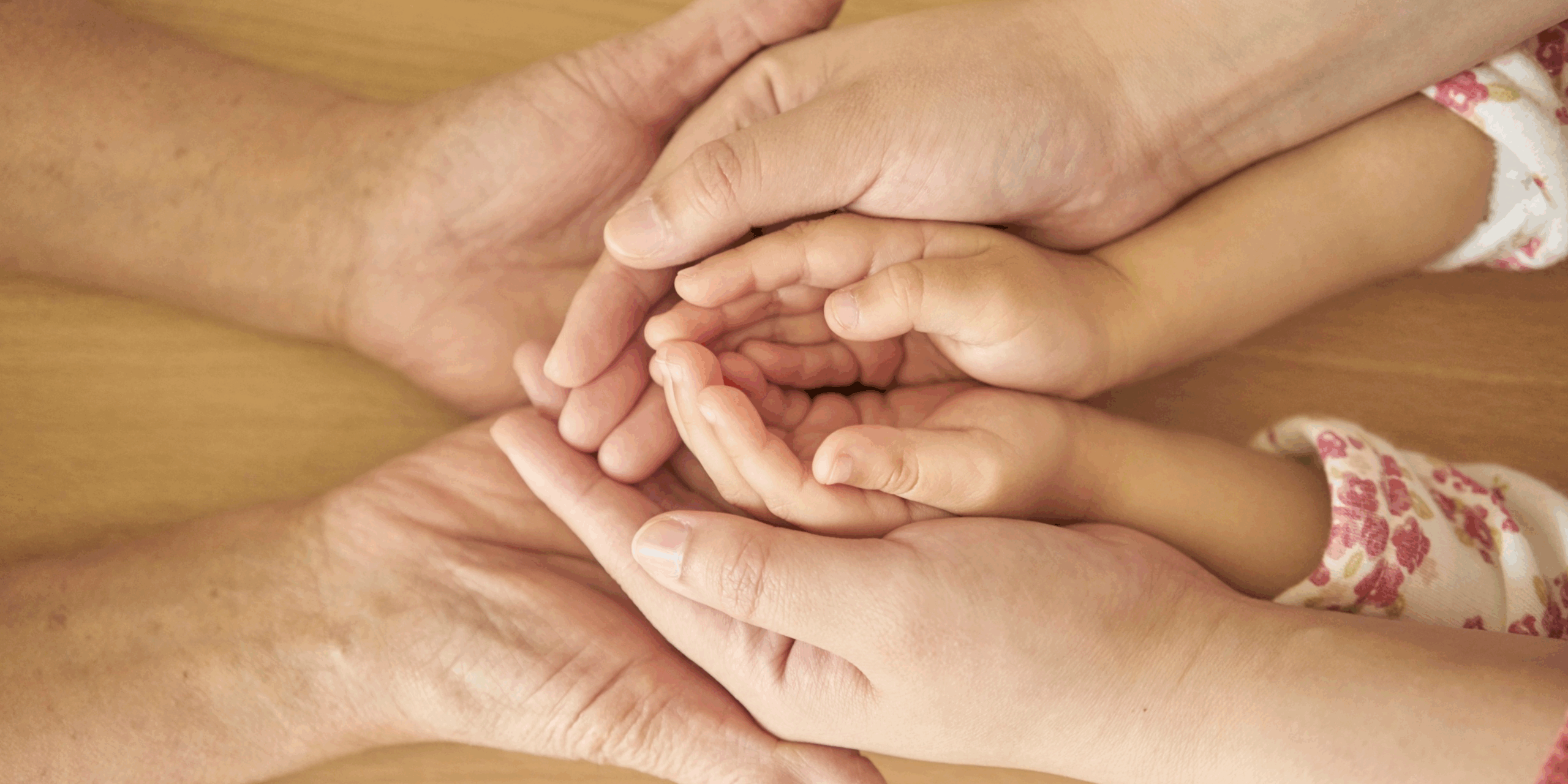 Parents holding child's hands to show supporting positive body image